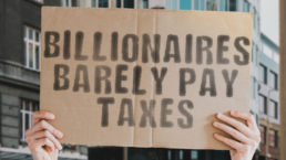 billionaires barely pay taxes sign
