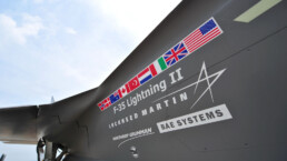 lags and names printed on the side of Lockheed Martin, F-35 Lightning fighter jet