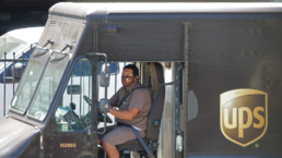 a UPS worker sits in his truck