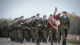 the polish army on exercises holding a flag and rifles