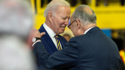 President Joe Biden Jr. greets Senator Charles Schumer before highlights funding for the Hudson River Tunnel project at West Side Yard gate in New York