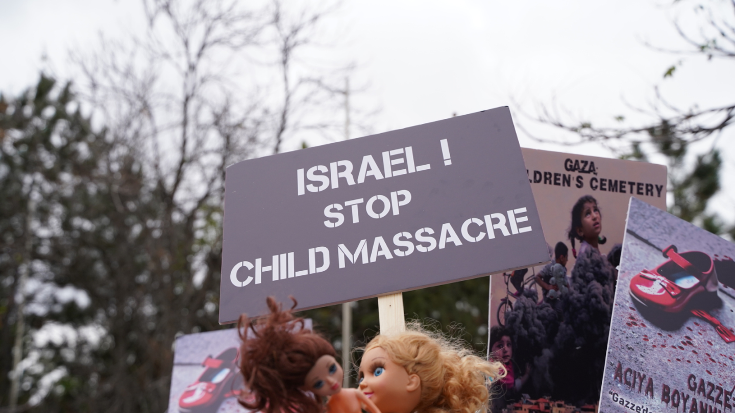 Israel stop child massacre protest sign