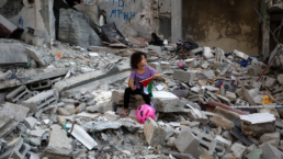 Palestinian child playing in rubble in Gaza