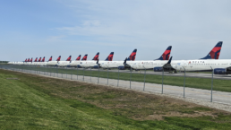 Delta planes parked on a tarmac in a line