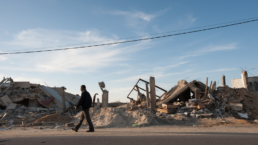 A man walk nears rubble made by an Israeli bomb that destroyed a medical clinic and other civilian structures serving a community of poor fishermen near Khan Yunis, Gaza