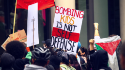 bombing kids is not self defense sign at protest 2023