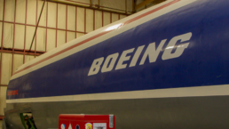 the side of a boeing plane fuselage showing the company name