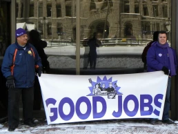 workers in minnesota hold a protest sign
