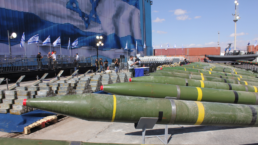 missiles sit in a lot near Israeli army personnel