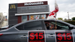 a car in front of mcdonalds with protest signs on it