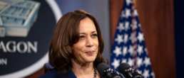 kamala stands at a podium