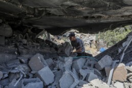 Palestinians inspect the site of an Israeli airstrike in Deir al-Balah, in the central Gaza Strip, on August 10, 2024
