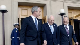 george bush and dick cheney walk next to donald rumsfeld