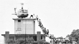people board a helicopter atop a building