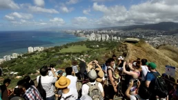 tourists take pictures in hawaii