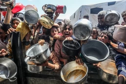 Palestinians receive meals from volunteers in the Mawasi area of Khan Yunis, in the southern Gaza Strip, on April 26, 2025.
