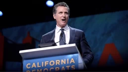 gavin newsom speaks at a podium