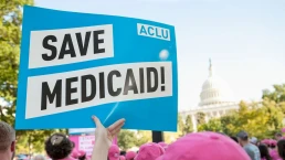 a save medicaid poster at a rally