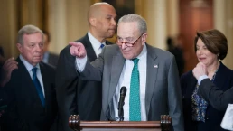 democratic leaders stand at a podium