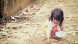 a poor child looking for items on the street