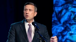 ken martin speaks at a podium