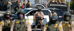 Police guard as a protest outside a Sheriff's Station to demand prosecution of the deputies who were involved in the shooting deaths of Anthony Weber and Dijon Kizzee, Sept. 27, 2020 in Los Angeles.
