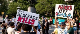 protest signs that say the blockade kills and hands off cuba