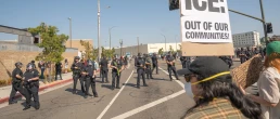 Los Angeles, USA – June 8, 2025: Man holding protest sign during a downtown demonstration against expanded ICE operations and in support of immigrant rights.