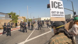 Los Angeles, USA – June 8, 2025: Man holding protest sign during a downtown demonstration against expanded ICE operations and in support of immigrant rights.