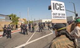 Los Angeles, USA – June 8, 2025: Man holding protest sign during a downtown demonstration against expanded ICE operations and in support of immigrant rights.