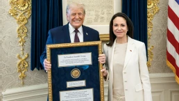 trump with maria machado as she gives him her nobel prize