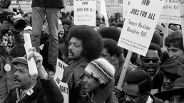 Jesse Jackson surrounded by marchers carrying signs advocating support for the Hawkins-Humphrey Bill for full employment, near the White House, Washington, D.C.