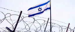 View of israeli flag behind barbed wire against cloudy sky. border post on the border of israel. The checkpoint at the embassy of the country. the Palestinian-Israeli border.