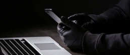 black gloves government agent spying on cell phones and computers