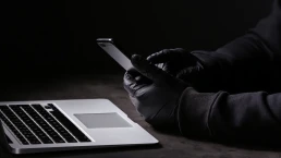 black gloves government agent spying on cell phones and computers