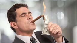 rich guy burning money with cigar