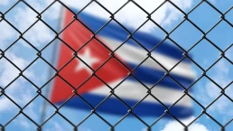 Cuban flag behind fence