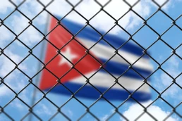 Cuban flag behind fence