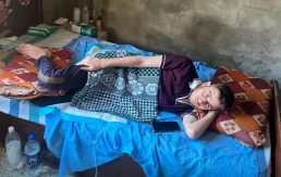 Mohammed Khaled Afana lying in bed, unable to move. - Truthout