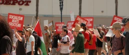 San Diego, California, United States - March 28th, 2026: No Kings peaceful protest march at waterfront park, people holding anti ice, trump, fascism, war signs on sunny day, socialism beats fascism democratic socialists of america signs (dsa) with downtown san diego high rise buildings backdrop