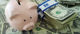 Putting money into a piggybank