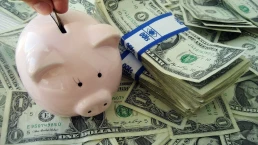 Putting money into a piggybank