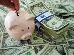 Putting money into a piggybank