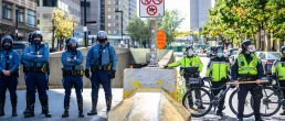 Boston, Massachusetts, USA – October 18, 2020: Police officers and bicycle patrol officers stand near a downtown street during a public demonstration in Boston.
