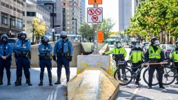 Boston, Massachusetts, USA – October 18, 2020: Police officers and bicycle patrol officers stand near a downtown street during a public demonstration in Boston.