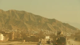 PULI KHUMRI, AFGHANISTAN, MAR 21, 2011: American military convoy travels through the town of Puli Khumri Afghanistan in Baghlan Province.