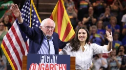U.S. Senator Bernie Sanders and U.S. Congresswoman Alexandria Ocasio-Cortez speaking with attendees at a
