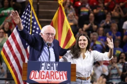 U.S. Senator Bernie Sanders and U.S. Congresswoman Alexandria Ocasio-Cortez speaking with attendees at a 