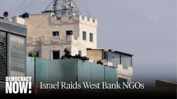 Democracy Now thumbnail, IDF outpost guards, “Propaganda Show”: IDF Raids Palestinian NGOs in the West Bank Ahead of Israeli Elections